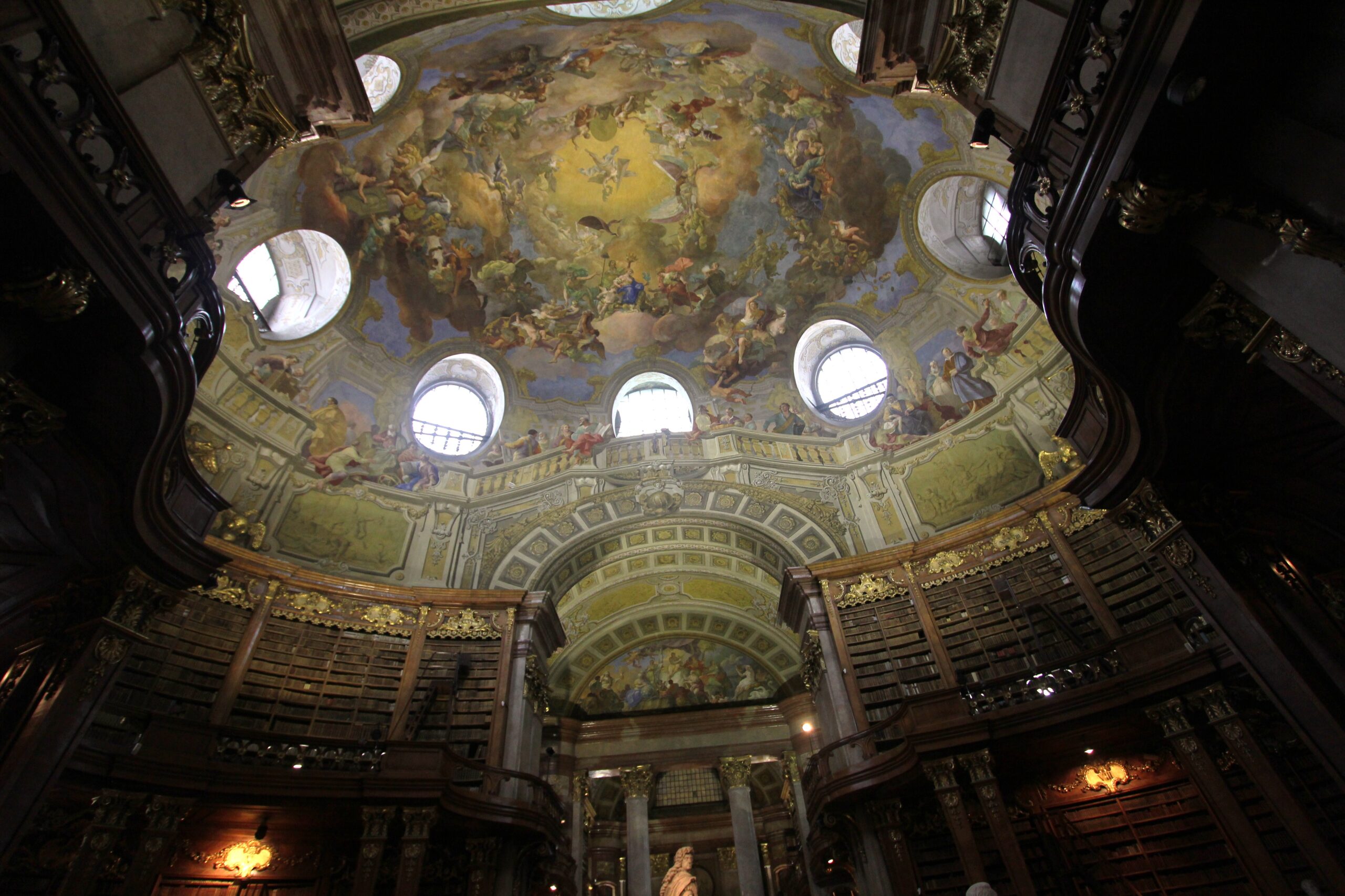 The painted dome of the State Hall of the Austrian National Library, with Daniel Gran's frescoes above the oval windows and bookcases