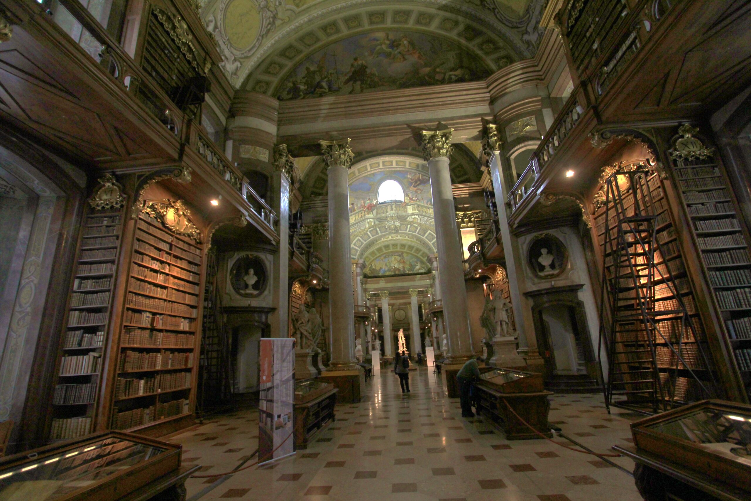 Marble columns, carved wooden galleries and library ladders along the State Hall of the Austrian National Library